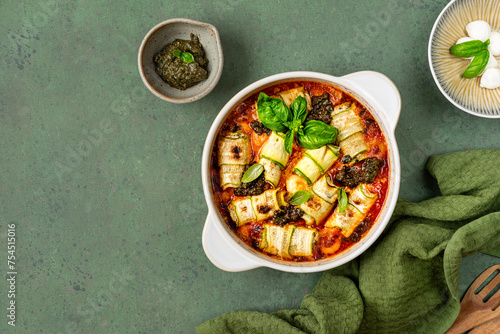 Zucchini lasagna rolls stuffed with ricotta, baked in tomato sauce.