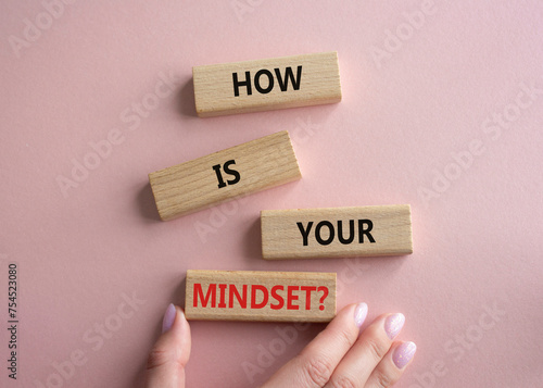 Mindset symbol. Wooden blocks with words How is your Mindset. Beautiful pink background. Businessman hand. Business and How is your Mindset concept. Copy space.