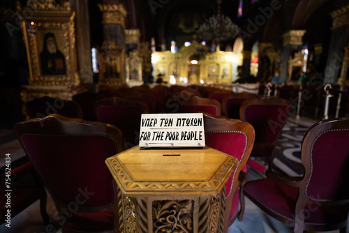 Obraz na płótnie Zakynthos, Greece - September 22, 2022: Donation box saying for poor people kept inside a church or temple w salonie