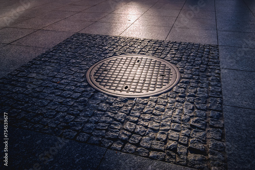 Historic manhole cover used by the insurgents during the Warsaw Uprising on Nowy Swiat Street, Poland photo