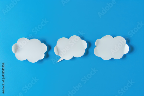 Three clouds with speech bubbles on blue background