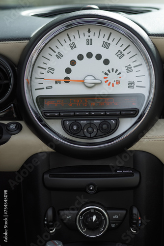 Close up of Mini Cooper dashboard with Speedometer, Odometer, and vehicle gauge