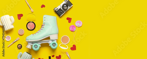 Composition with vintage roller skate, photo camera and cosmetic products on yellow background photo