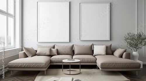 A stylish  contemporary space with a taupe sectional and empty white frames