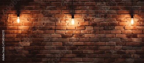 A brick wall adorned with three vintage lights, casting a warm glow on the weathered surface. The lights stand out against the rough texture of the wall, creating a unique visual contrast.