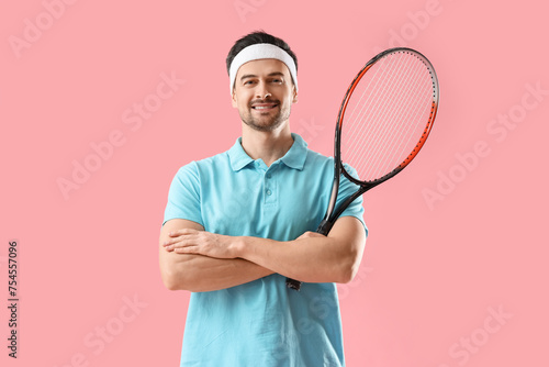 Portrait of male tennis player on pink background © Pixel-Shot