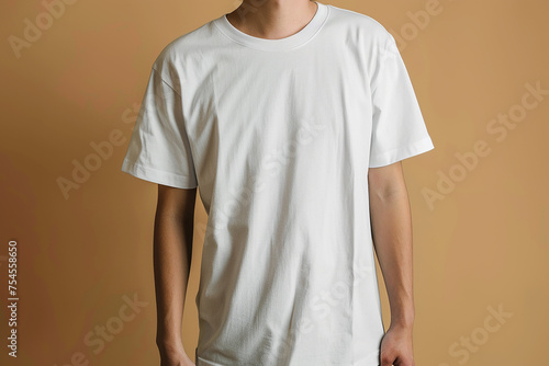 Man wearing a white t-shirt on a light grey background, closeup. Mockup for design