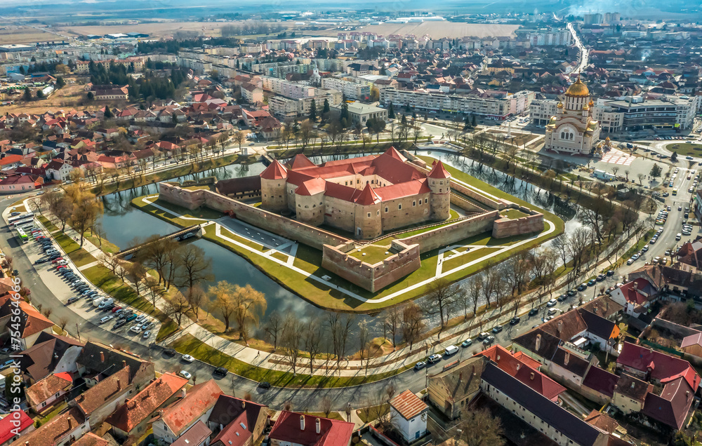 Aerial view with Fagaras Citadel Fortress and the mountains in Romania
