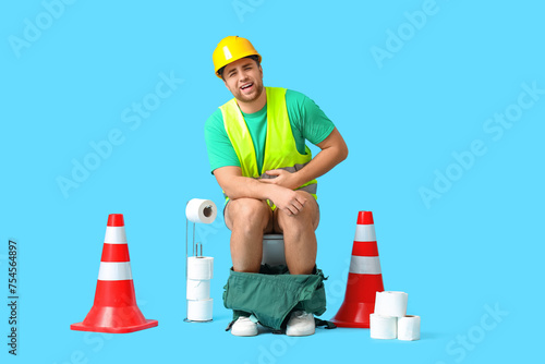 Male worker sitting on toil...