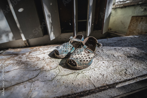 Old shoes in Kindergarten No. 10 Cheburashka in Pripyat ghost city in Chernobyl Exclusion Zone, Ukraine