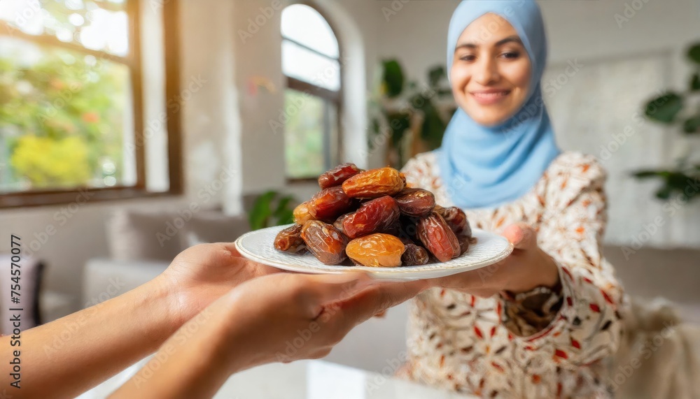 Concept Giving or Charity during Ramadhan Holy Month, Female Muslim Hand Over A Plate of Dates Fruit hurma to Other. Ifthar and Ramadan Kareem Concepts. Concept Giving or Charity during Ramadhan Holy Month, Female Muslim Hand Over A Plate of Dates Fruit hurma to Other. Ifthar and Ramadan Kareem Concepts.