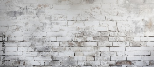 A black and white photograph showcasing the texture of an old white brick wall in a new construction interior. The worn bricks create a sense of history and add character to the space.