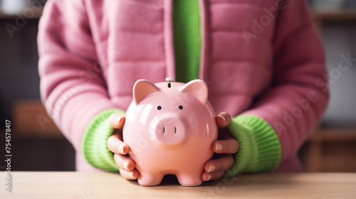 Woman holding Piggy bank with a blurred background