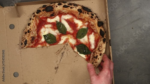 Best owen baked italian pizza margherita eaten right from delivery paper box. Top view, 4K stop motion animation.