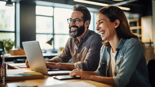 Portrait of successful business people with laptop discuss business issues in the office