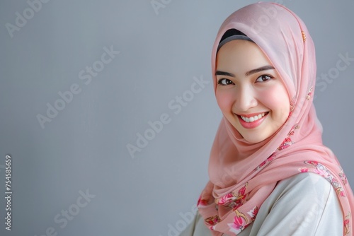 Portrait of islamic woman smiling. Pretty muslim girl. Beautiful asian muslimah woman model posing on grey wall studio. Portrait Of Arab Beauty  copy space - generative ai