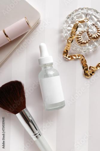 mockup blank white label skincare product bottle styled in a feminine setup, gold jewelry, crystal dish, cosmetic beauty essentials, makeup brush, lipstick, notebook