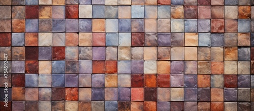 A vintage-styled mosaic tiled wall featuring a variety of brown and blue hues, creating a textured and visually dynamic surface.