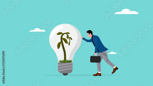 sad businessman leaning on dead light bulb idea with dead plants, unsustainable business ideas concept, industries that do not use environmentally friendly energy or renewable energy