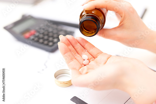Close up woman holding pill