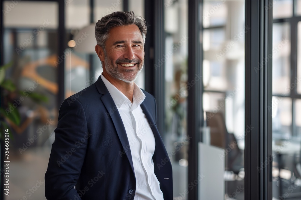 Fototapeta premium Happy business man wearing suit standing in office