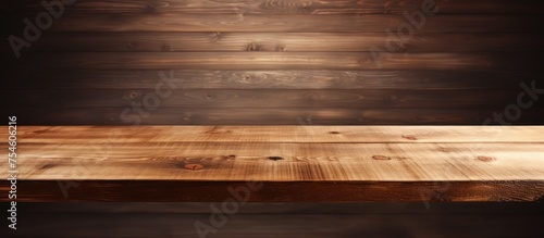 A wooden table is positioned in front of a wooden wall, creating a simple yet rustic setting. The table stands out against the wall, offering a natural and warm aesthetic.