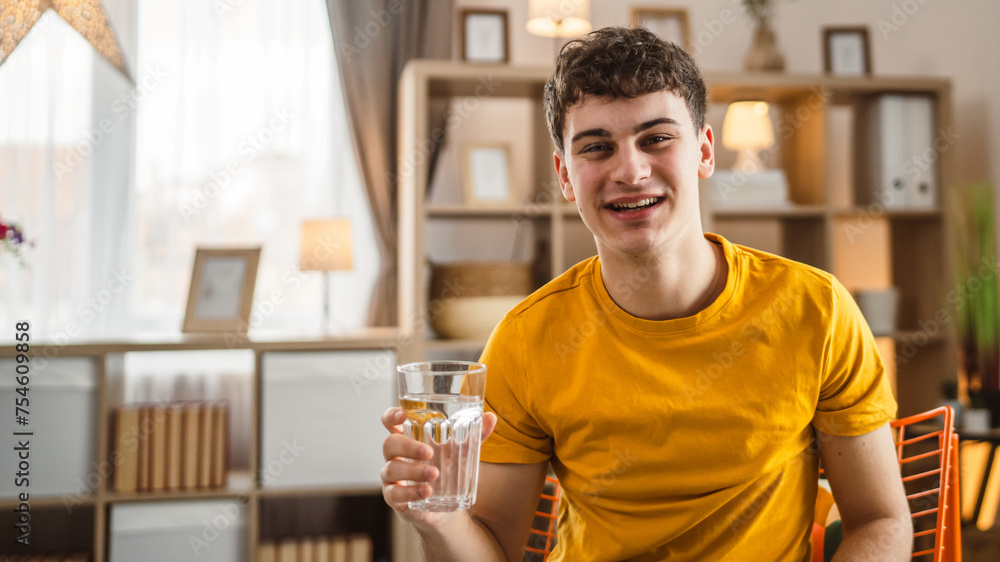 man young caucasian male hold glass of water at home