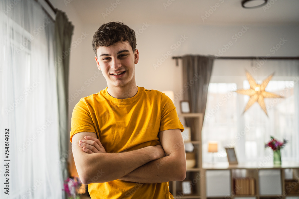 Fototapeta premium Portrait of young caucasian teen male young man stand at home