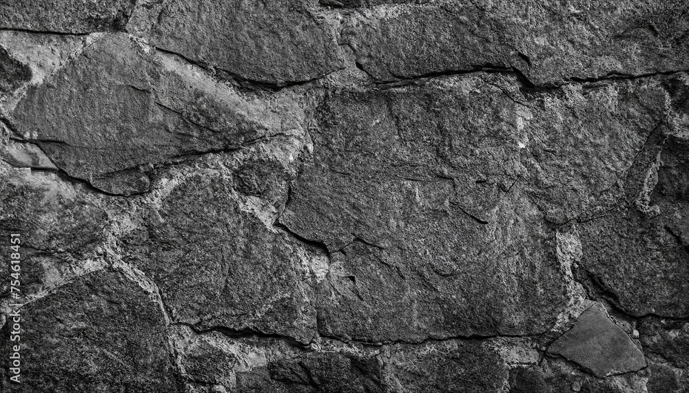 Backdrop of black and white. Black rock texture. Close-up. Stone wall background for design. Copy space. Wide banner.