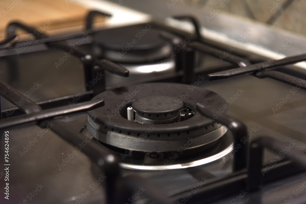 Metal home gas stove not working - empty burner, blurred background, selective focus, fuel shortage, gas shutdown, europe without gas, russian gas, cold winter Metal home gas stove not working - empty burner, blurred background, selective focus, fuel shortage, gas shutdown, europe without gas, russian gas, cold winter