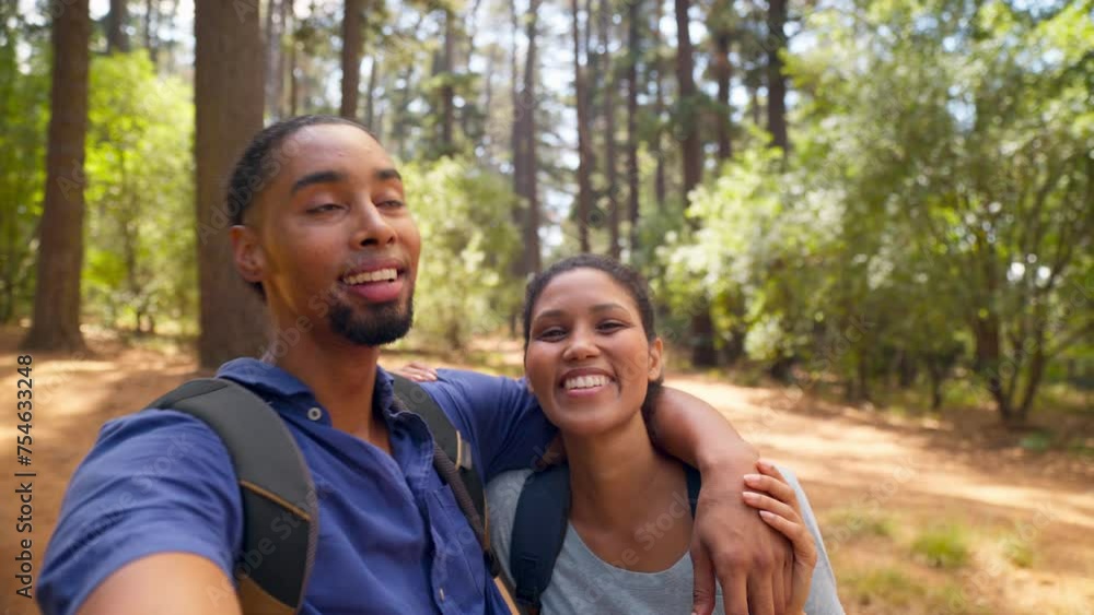 POV shot of young active couple wearing backpacks hiking along trail recording video or making video call on mobile phone in summer forest countryside - shot in slow motion POV shot of young active couple wearing backpacks hiking along trail recording video or making video call on mobile phone in summer forest countryside - shot in slow motion