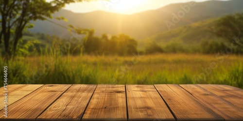 Empty wooden table with a soft focus on the tranquil morning landscape, sun rays filtering through the trees.