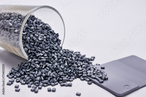 pearl silver masterbatch granules on a white background, equipped with a color chip as an example of the color produced, this polymer is a coloring product for products in the plastics industry