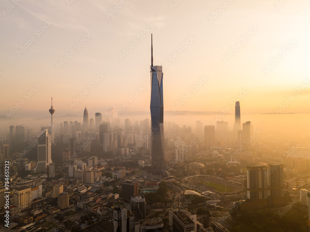 Obraz premium Aerial golden sunrise at Kuala Lumpur city skyline.