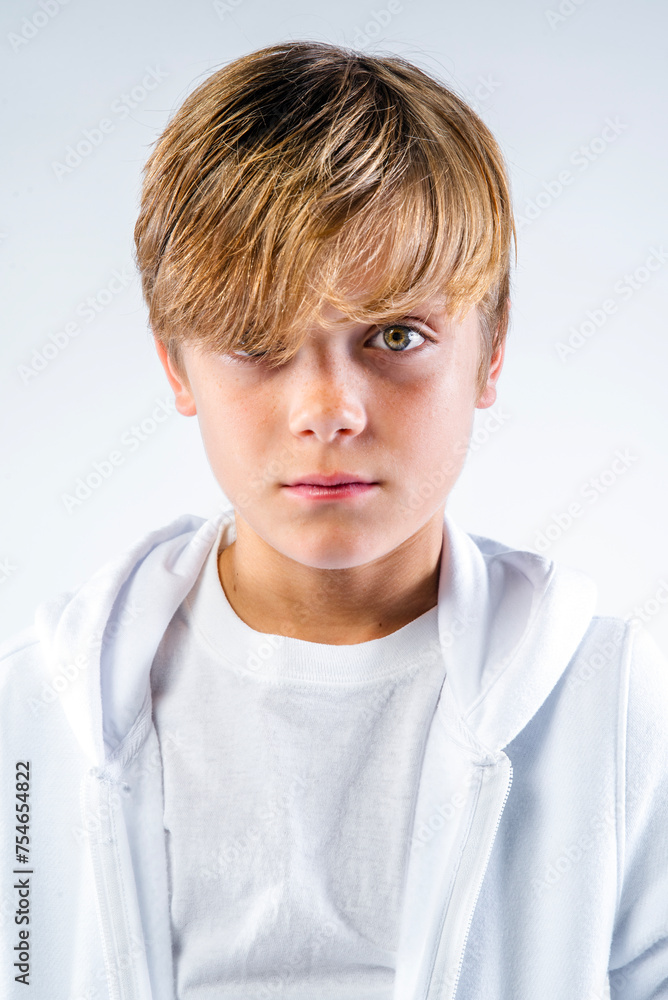 Head and shoulders portrait of a cute preteen boy dressed in white Head and shoulders portrait of a cute preteen boy dressed in white