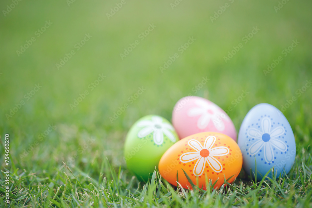 Collection of colorful easter eggs on green grass to celebrate Easter or spring.