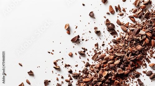 Close-up shot of cacao nibs scattered on white background.