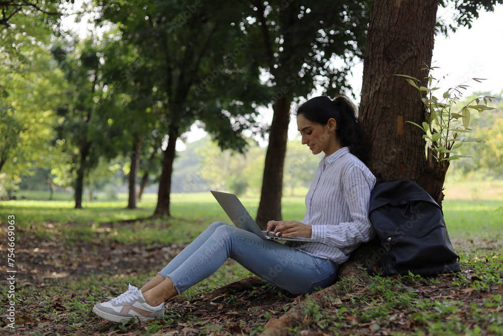 beautiful young woman relaxation working at garden tree in holiday. beautiful young woman relaxation working at garden tree in holiday.