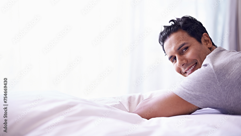 Man, smile and portrait on bed for happy and relax at home or indoor on weekend and alone. Young person, attractive or handsome for unwind, rest or chill in apartment on mattress inside South Africa - obrazy, fototapety, plakaty 