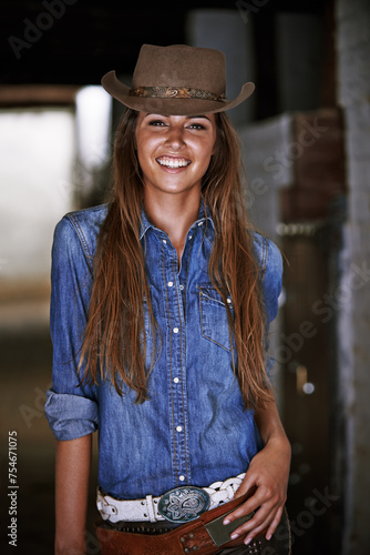 Woman or cowgirl, happy and portrait in stable for work or rodeo in Texas, western and culture for farming. Female cowboy or jockey, ranch and hat for barn agriculture and countryside with equestrian