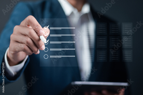 Business performance checklist, Business evaluation, project approval and enhancing business performance. Businessman checking mark on check box to approved documents.