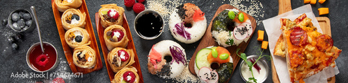 Hybrid trendy food on dark background. Sushi roll pancake, donut sushi, pizza with pasta