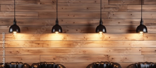 A row of chairs is neatly arranged in front of a wooden wall in a studio with textured black ceilings. Light lamps illuminate the scene, creating a simple and functional seating area.
