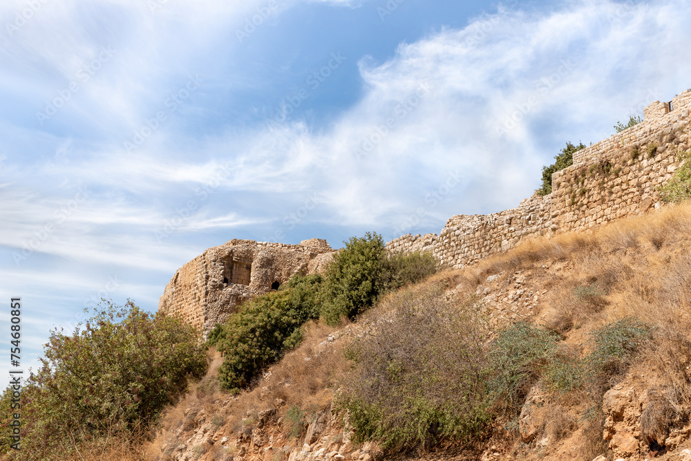 Bottom view of hill with ruins of fortress walls and  corner tower of medieval fortress of Nimrod - Qalaat al-Subeiba, located near the border with Syria and Lebanon on the Golan Heights, Israel