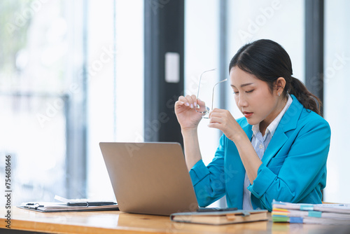 Wallpaper Mural Asian businesswoman wear glasses working on digital laptop computer at table office. Technology and digital marketing online concept. Torontodigital.ca