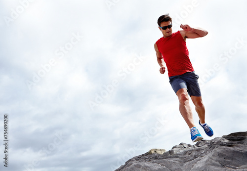 Bilde på lerret Man, running and beach for fitness, health and wellness in activewear and sunglasses