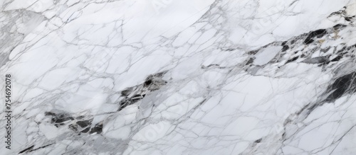 Detailed close-up view of a white marble texture, showcasing the intricate veining and smooth surface of the stone. Ideal for background or design purposes.