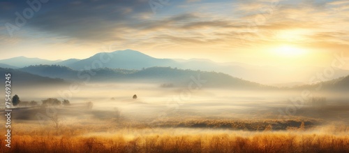 A car is seen driving through a foggy field with the sun shining on the mist in the early hours of an autumn morning. In the distance, majestic mountains rise against the misty backdrop.