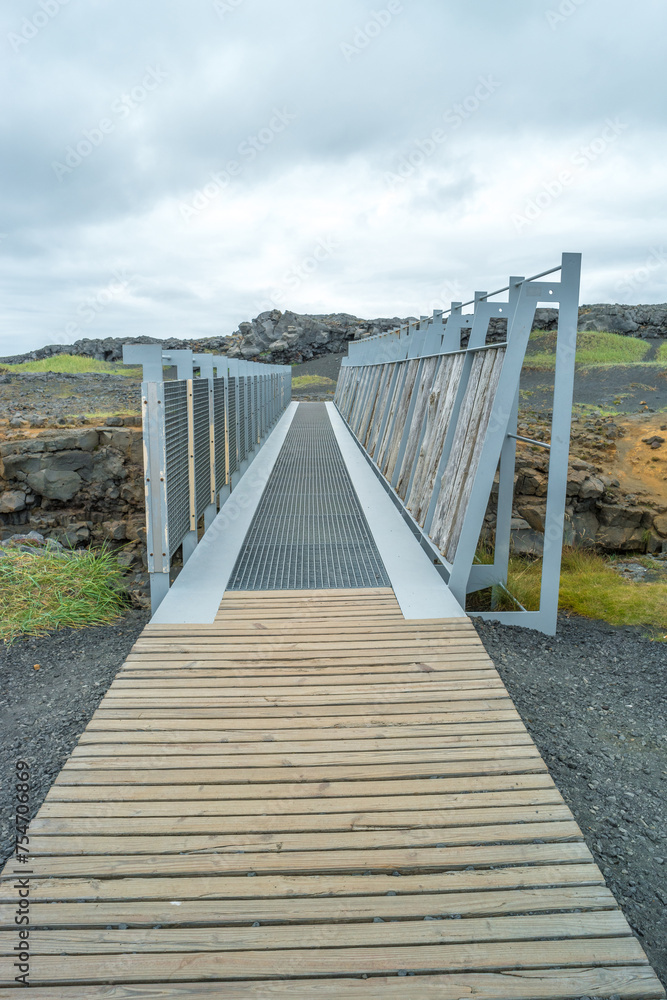 Middle Atlantic Ocean Ridge, bridge between two tectonic plates, Midlina,  famous tourist attraction in Iceland with lava field cracks, cliffs and rocks