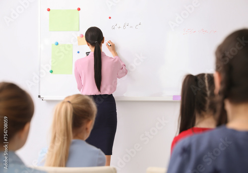 Young teacher and students in modern classroom